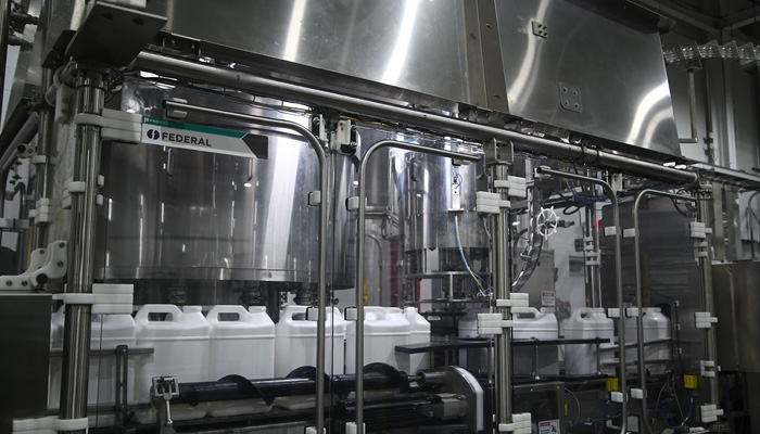 XACT-FIL net weight filler from Fedeal fills canisters 