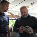 ProMach MBF technicians examining precision packaging automation tooling