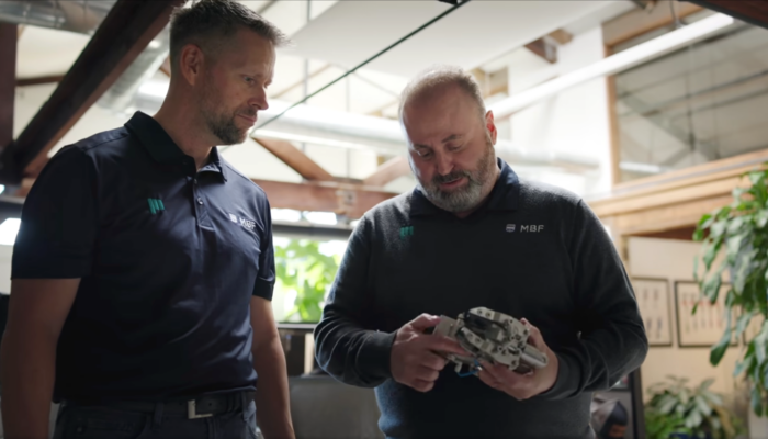 ProMach MBF technicians examining precision packaging automation tooling